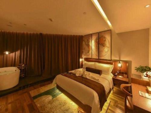 a bedroom with a large bed and a bath tub at James Joyce Coffetel·Beijing Yizhuang Development Zone Dazu Square Tongji Road in Beijing