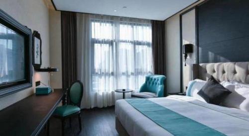 a hotel room with a bed and a large window at Xana Hotelle Chengdou Xindu Sanhechang Metro Station in Chengdu