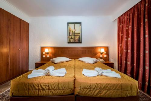 a bedroom with a bed with two towels at Gaia Garden in Kos Town