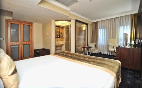 a hotel room with a bed and a bathroom at CK Farabi Hotel in Ankara