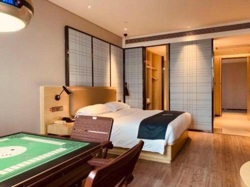 a bedroom with a bed and a pool table at Echarm Hotel Changde Taoyuan Walking Street Jinyuan Tower in Changde
