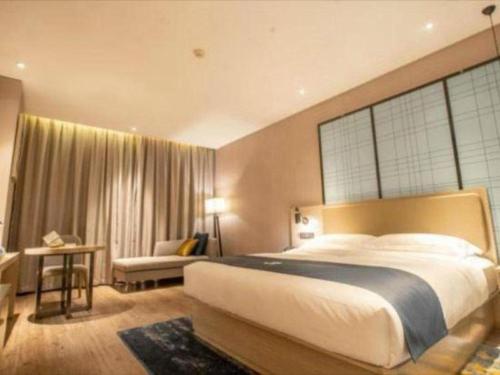 a bedroom with a large bed with a large window at Echarm Hotel Changde Taoyuan Walking Street Jinyuan Tower in Changde