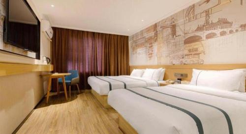 a hotel room with three beds and a television at City Comfort Inn Guilin Two Rivers and Four Lakes Sun and Moon Shuangta in Guilin