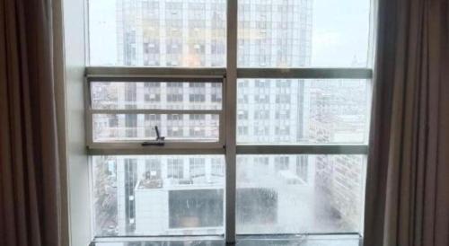 a window with a view of a city at Xana Hotelle Nanchang Tengwang Pavilion Wanshougong in Nanchang