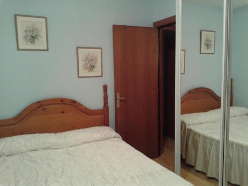 a bedroom with two beds and a mirror at Can Mestre in Cambrils