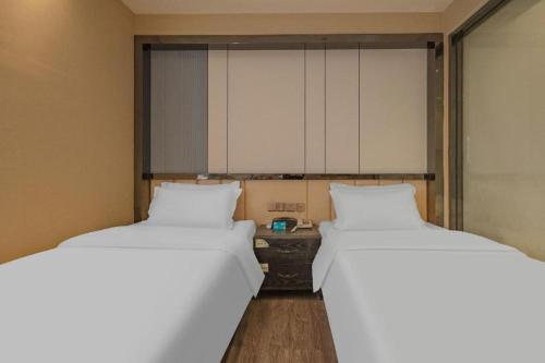 Postel nebo postele na pokoji v ubytování PAI Hotels Shijiazhuang Zhengding Gucheng
