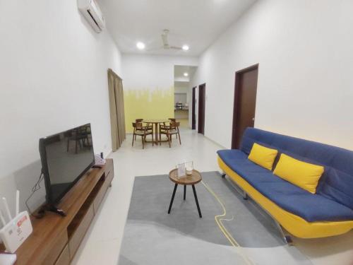 スレンバンにある51 Lyrica Seremban 2 Best stayの青いソファとテレビのあるリビングルーム