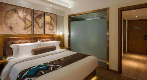 a bedroom with a large bed and a glass door at James Joyce Coffetel Kunming Railway Station Huancheng Nan Road Metro Station in Kunming