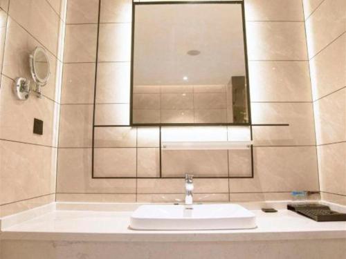 a bathroom with a sink and a mirror at Xana Lite Hotelle Yan'an Baota Mountain in Yan'an