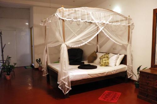 Ένα ή περισσότερα κρεβάτια σε δωμάτιο στο Tamasha Mango Home stay