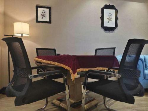 a table with chairs around it with a cloth on it at Xana Lite Hotelle Yan'an Baota Mountain in Yan'an