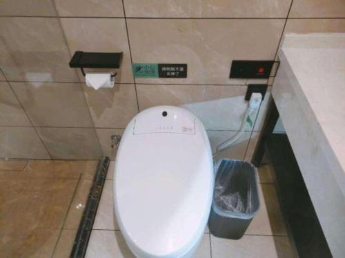 a bathroom with a white toilet in a stall at Xana Lite Hotelle Yan'an Baota Mountain in Yan'an