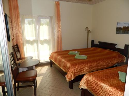 a hotel room with two beds and a window at Greta in Druskininkai