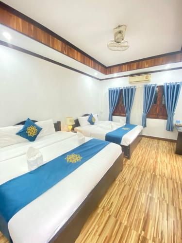 Postel nebo postele na pokoji v ubytování Luangprabang Singharat Place 2
