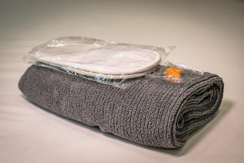 a bag with a pillow on top of a towel at Bellevue Apartments Middlesborough in Middlesbrough
