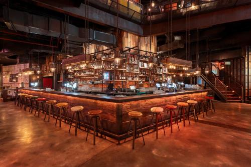 a bar with stools in a large room at Rixos Premium Dubai JBR in Dubai