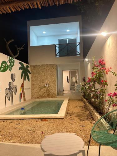 a swimming pool in the middle of a house at Casa Ha Hermosa Casa en Progreso Yucatan in Progreso