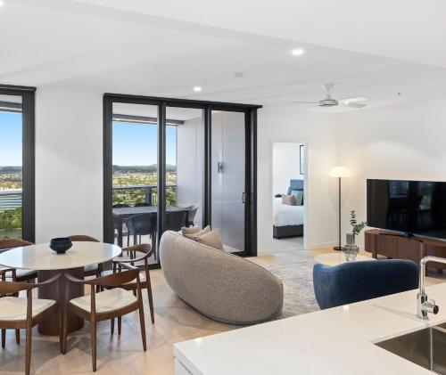 a living room with a couch and a table at Queen's Wharf Residences Official in Brisbane