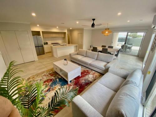 a living room with a couch and a table at Spacious Holiday Home - 500m from the Beach! in Saint Leonards