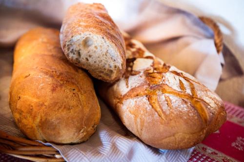 three loaves of bread sitting on top of a basket at Hotel Marmotte in Saas-Fee