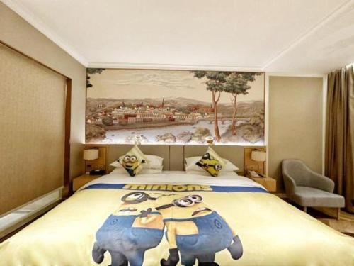 a hotel room with a large bed with a painting of elephants at Vienna Hotel Hangzhou East Railway Station West Square in Hangzhou
