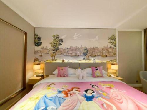 a bedroom with a large bed with a painting on the wall at Vienna Hotel Hangzhou East Railway Station West Square in Hangzhou