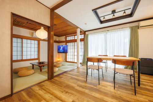 a dining room with a table and chairs at Sankuya House in Kawaguchi