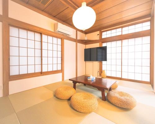 a living room with a table and two stools at Sankuya House in Kawaguchi