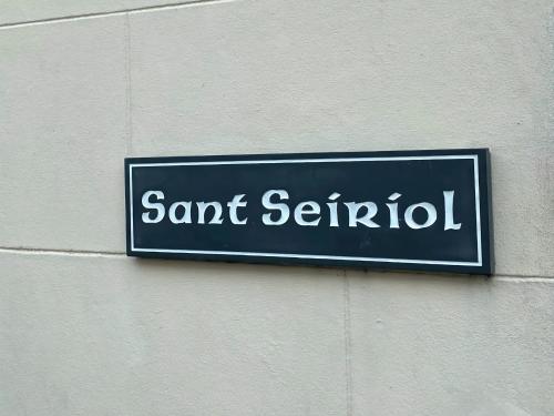 a sign on the side of a building at Sant Seiriol in Beaumaris