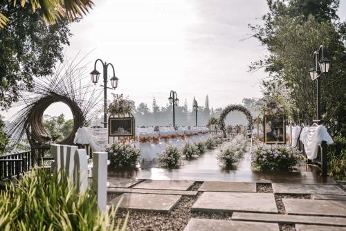 a wedding aisle with an arch and flowers at Lido Lake Resort by MNC Hotel in Bogor