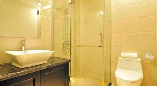 a bathroom with a toilet and a sink and a shower at Super 8 Hotel Guiyang Qianling Park Ruijin North Road in Guiyang
