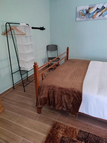 a bedroom with a bed and a chair in it at Casa das Escadinhas in Vale de Mendiz