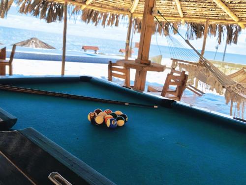 a pool table with balls on top of it on a beach at Cabañas en Playas Villamil, Bungalows! in Playas