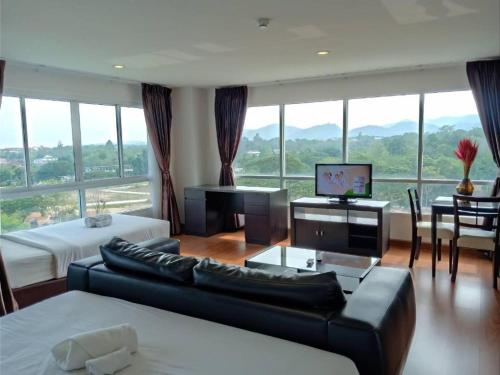 a large living room with a couch and a television at The Living-Hills in Chiang Mai