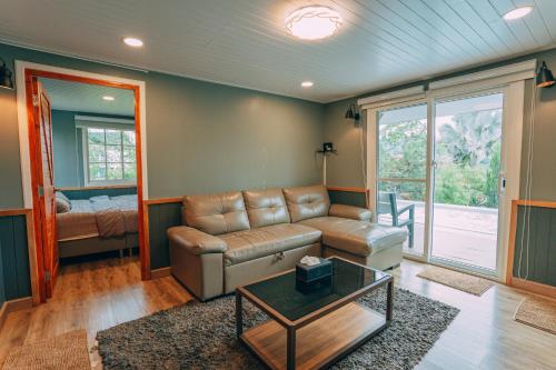 a living room with a couch and a table at Khaoyai Art Tree in Pong Talong