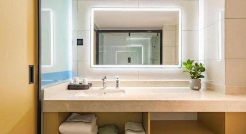 a bathroom with a sink and a mirror at City Comfort Inn Kunming Dashuying Yejin Hospital Wangdaqiao in Kunming