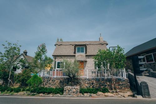 a stone house with a stone wall at Khaoyai Art Tree in Pong Talong