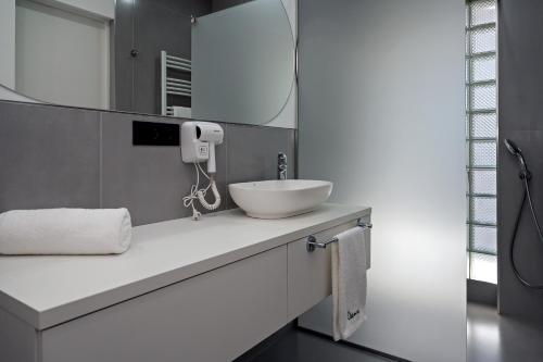a bathroom with a white sink and a mirror at DilijanInn Hotel and Restaurant in Dilijan