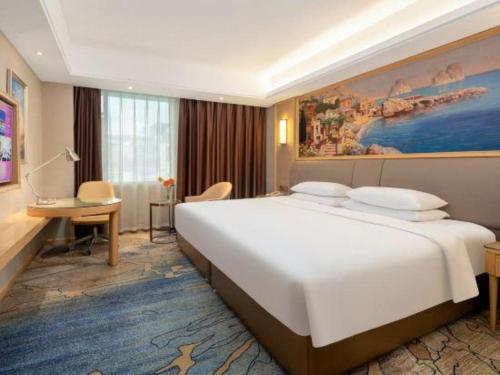 Ένα ή περισσότερα κρεβάτια σε δωμάτιο στο Vienna Hotel Guangzhou Yonghe Development Zone