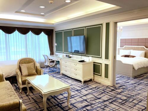 a hotel room with a bed and a television at Koreana Hotel in Seoul
