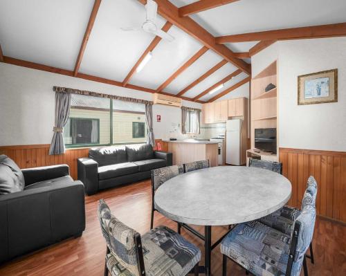 a living room with a table and chairs at Albury Holiday Park in Albury