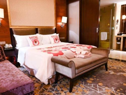 a bedroom with a large bed and a couch at Royal Tulip Hotel Zhujiajiao Shanghai in Shanghai