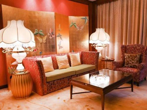 a living room with a couch and a table at Royal Tulip Hotel Zhujiajiao Shanghai in Shanghai