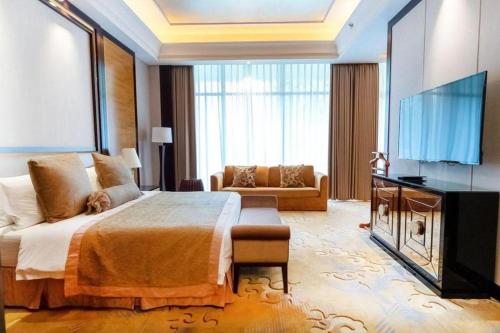 a bedroom with a large bed and a flat screen tv at Royal Tulip Hotel Zhujiajiao Shanghai in Shanghai