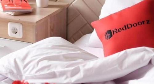 a red laptop sitting on top of a bed at Ha Noi Vang Hotel Hoang Ngan in Hanoi