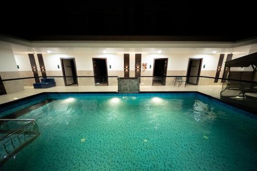a large swimming pool in a building at Hotel Navil Exotica in Chicalim