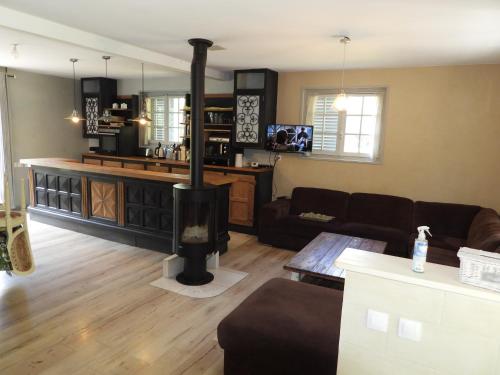 a living room with a wood stove in the middle at Nid dans la forêt in Saint-Jean-aux-Bois