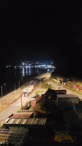 a view of a street at night with a city at Playa Tomé Chile in Tomé