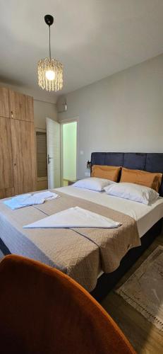 a bedroom with two beds and a chandelier at SWEET & CHILLI Home 28 in Thessaloniki