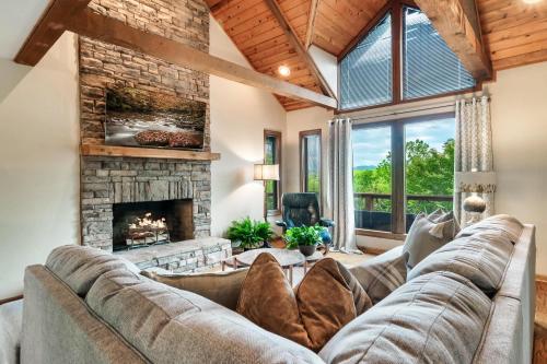 a living room with a couch and a fireplace at A Hikers Dream - 34 Acres Hot Tub Views Trails in Cosby